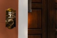 Kaboompics - Vintage Brass Apartment Intercom Beside a Dark Wooden Door