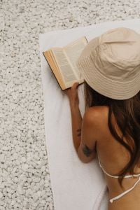 Kaboompics - Overhead Summer Reading Scene on a White Pebble Beach Towel
