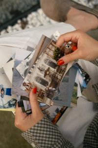 Kaboompics - Holding A Stack Of Printed Travel Photographs