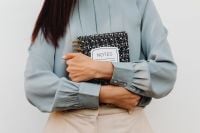 Kaboompics - Asian Woman Holding an Open Notes Notebook