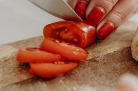 Kaboompics - Close-Up of Slicing Cherry Tomatoes on a Wooden Board