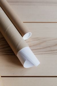Kaboompics - Kraft Cardboard Tubes and White Paper Roll with Copy Space on Wood