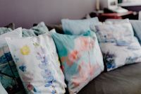 Kaboompics - Close-Up of White and Teal Decorative Pillows on a Gray Sofa