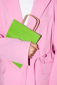 Kaboompics - Person in Pink Suit Holding a Bright Green Shopping Bag