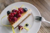 Kaboompics - Berry Cheesecake Slice with Raspberries, Blueberries and Lemon Peel