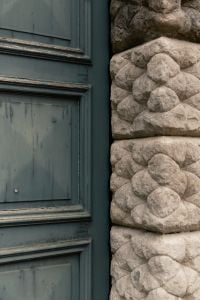 Kaboompics - Teal Wooden Door with Rustic Carved Stone Doorframe Detail, Italy