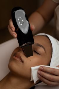 Kaboompics - Handheld Skincare Device Used on Woman's Face