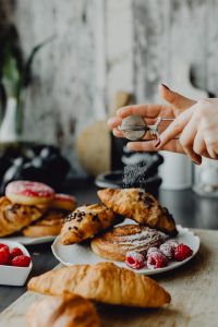 Kaboompics - Hand Sifting Powdered Sugar Over Croissants and Buns