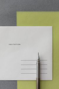 Kaboompics - Editorial Invitation Card and Silver Pencil on Lime Green Background