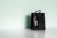 Kaboompics - Black Friday Shopping Bag and Long Shadow on Mint Green Background