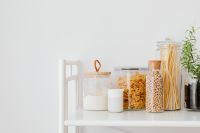 Kaboompics - Eco-Friendly Pantry Still Life with Glass Food Jars and Copy Space on Neutral Wall