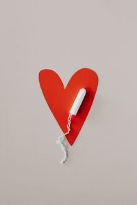 Kaboompics - White Tampon on a Red Heart, Feminine Health Concept in Portrait
