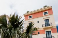 Kaboompics - Salmon Italian Villa Framed By Palm Leaves