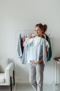 Kaboompics - Full-Length Teen Fashion Portrait with White Eyelet Top, Jeans and a Clothing Rack