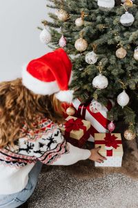 Kaboompics - Overhead View of Woman Arranging Christmas Gifts Under Tree