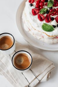 Kaboompics - Two Espresso Cups and Pavlova in a Vertical Neutral Dessert Arrangement