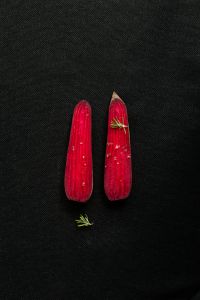 Kaboompics - Two Red Root Vegetables on a Black Background