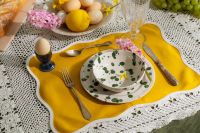 Kaboompics - Yellow Easter Place Setting with Green Polka Dot Plates and Egg Cup