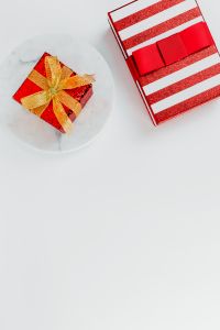 Christmas Gifts and Red Holiday Decorations on White Marble