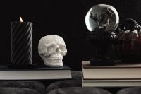 Kaboompics - Skull Candle and Crystal Ball on Stacked Books