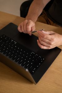 Kaboompics - Faceless Man Holding a Stylus Above a Laptop