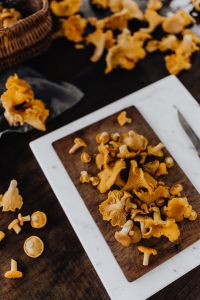 Kaboompics - Close Up Chanterelle Mushrooms On Cutting Board
