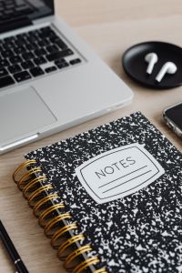 Kaboompics - Close-Up of Laptop, AirPods and Notes Notebook