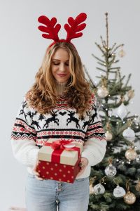 Kaboompics - Woman in Red Reindeer Antlers Holding a Wrapped Present