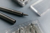Kaboompics - Close-Up of Fountain Pens and Organized Craft Fasteners