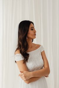 Kaboompics - Side-Swept Bridal Waves With Drop Earrings and an Embellished Gown