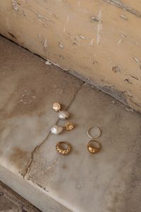 Kaboompics - Overhead Gold and Silver Jewelry Set with Chains, Pearl Earrings and Rings on Marble