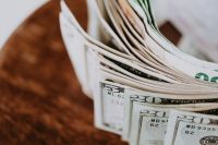Kaboompics - Fanned US Dollar Banknotes on a Wooden Table, Close-Up Currency Detail