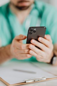 Kaboompics - Smartphone in Focus With Doctor Behind