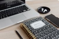 Kaboompics - Wide View of Laptop, AirPods, Smartphone and Notes Notebook on Desk