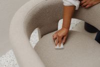 Kaboompics - Hand Cleaning a Curved Upholstered Chair