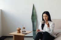 Kaboompics - Woman Sipping Coffee in a Minimal Living Room