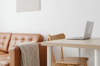 Kaboompics - Open Laptop at a Wood Desk in a Cozy Leather Sofa Living Room, Work From Home Editorial