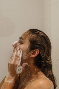 Kaboompics - Woman Washing Her Face with Skincare Foam in the Shower