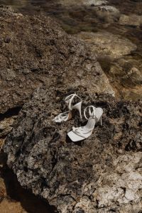 Kaboompics - White Minimal Sandals on Sunlit Rocks in Shallow Water
