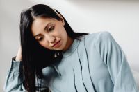 Kaboompics - Asian Woman Writing Notes During a Phone Call at Her Desk