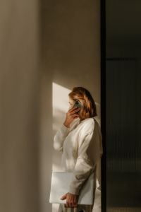 Freelance Photographer Working From Home With Laptop, Camera and Smartphone