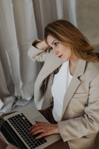 Businesswoman at Work with Financial Charts, Laptop and Office Breaks
