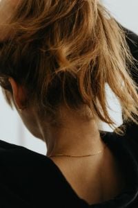 Kaboompics - Back View of Woman Wearing Gold Necklace and Black Top