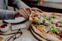 Kaboompics - Reaching for a Pizza Slice During a Shared Dinner