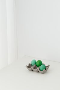 Kaboompics - Close-Up of Green Painted Easter Eggs in a Paper Carton