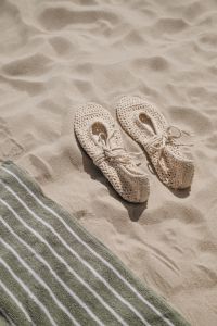 Kaboompics - Beige Crochet Espadrilles Beside a Striped Beach Towel