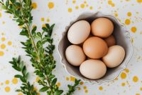 Kaboompics - Speckled Easter Eggs in a Ceramic Bowl with Olive Branch