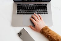 Kaboompics - Man works on a computer at his desk, mobile phone