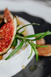 Kaboompics - Vertical Macro of Figs, Rosemary and Almonds on Camembert