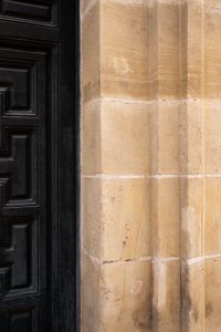 Kaboompics - Black Door and Warm Sandstone Wall